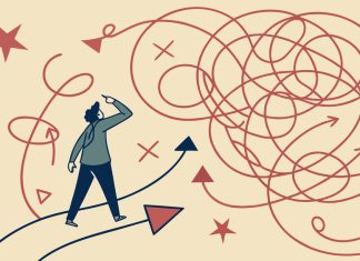 Rethinking Risk in Industrial and Manufacturing Environments Confused businessman standing at crossroads looking for solution to complex problem choosing right direction finding way out of tangled road