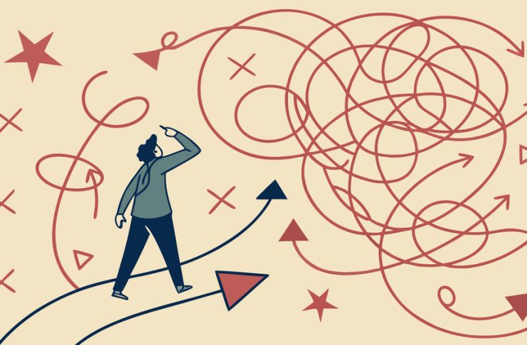 Rethinking Risk in Industrial and Manufacturing Environments Confused businessman standing at crossroads looking for solution to complex problem choosing right direction finding way out of tangled road